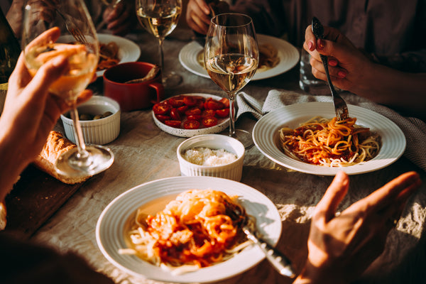 Italian dinner with spaghetti dishes and wine