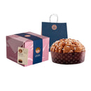 A boxed Fiasconaro Panettone Mandorle with Almonds with a gift bag and the panettone beside the package.
