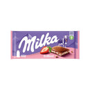 A packaged bar of Milka Strawberry Yogurt Chocolate showing the brand's logo, a cow, a strawberry and a chocolate piece.