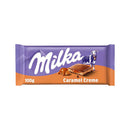 A packaged bar of Milka Caramel Milk Chocolate showing the brand logo, cow and a chocolate piece.