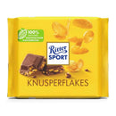 A packaged bar of Ritter Sport Milk Chocolate with Cornflakes, showing the brand's logo and chocolate pieces with cornflakes.