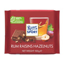 A wrapped bar of Ritter Sport Rum Raisin and Hazelnut Milk Chocolate showing the brand logo, chocolate pieces, hazelnuts and
