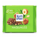 A wrapped bar of Ritter Sport Milk Chocolate with Hazelnut Pieces, showing the brand logo, chocolate pieces and hazelnuts.