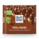 A packaged bar of Ritter Sport Whole Hazelnut Milk Chocolate, showing the chocolate, a hazelnut and the brand's logo.